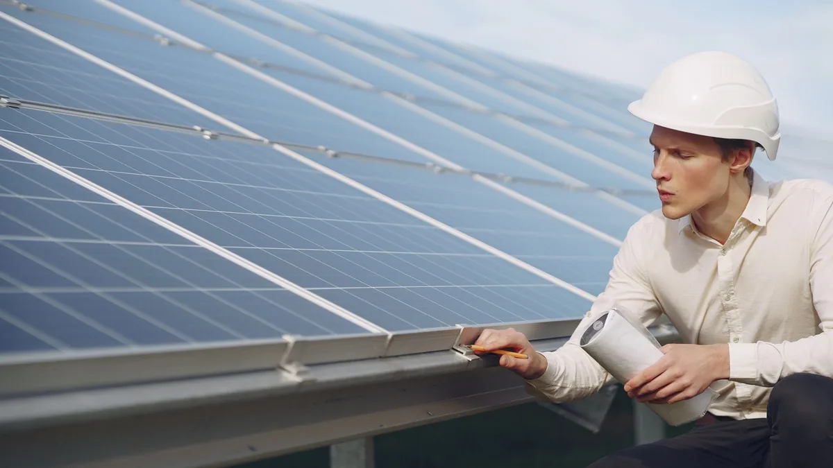 Technician inspecting rooftop solar panels in Winston-Salem, NC